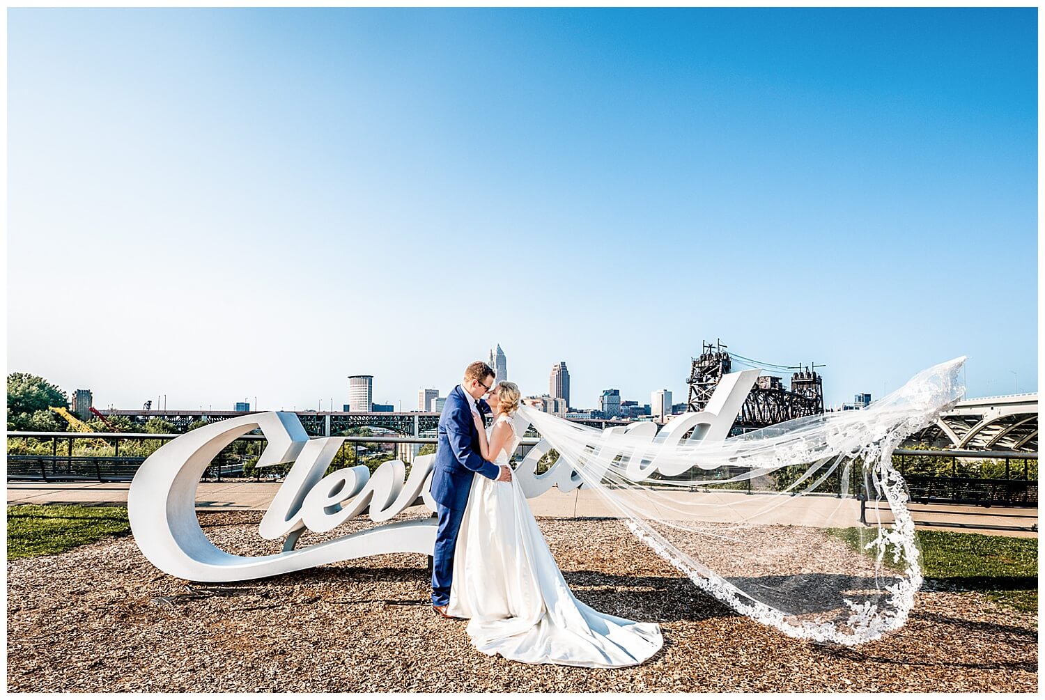 one of the best places to take wedding photos in cleveland, couple in front of the tremont cleveland sign