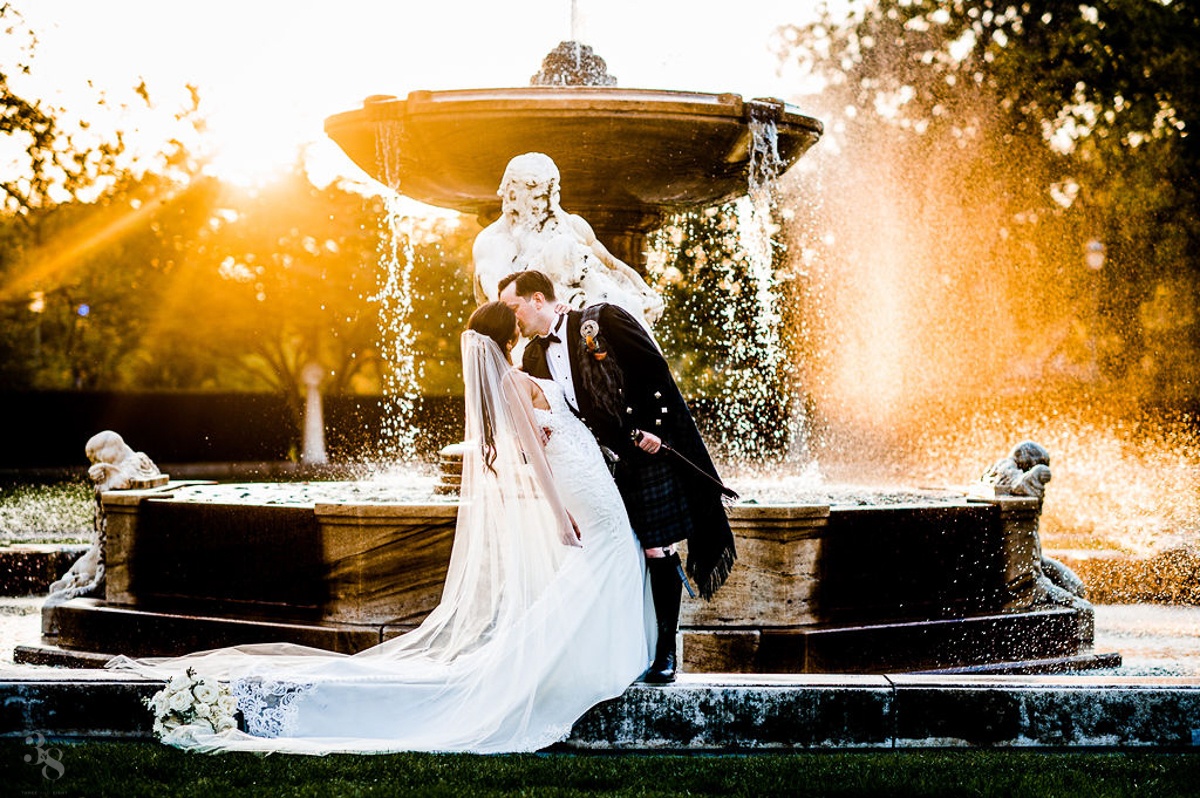 bride and groom in front of fountain at cleveland tudor arms hotel wedding in cleveland