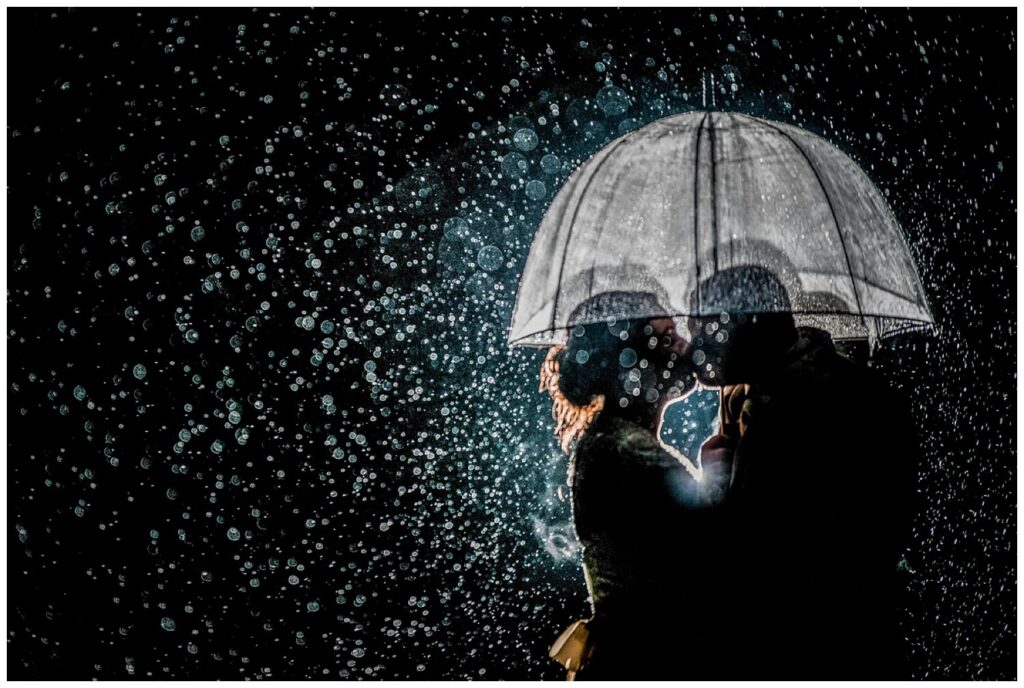couple's cleveland wedding planning for rain with clear umbrella at night