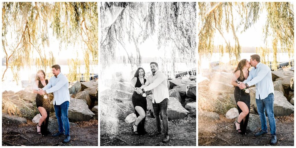 bride and groom popping champagne by weeping willow tree at edgewater beach ohio