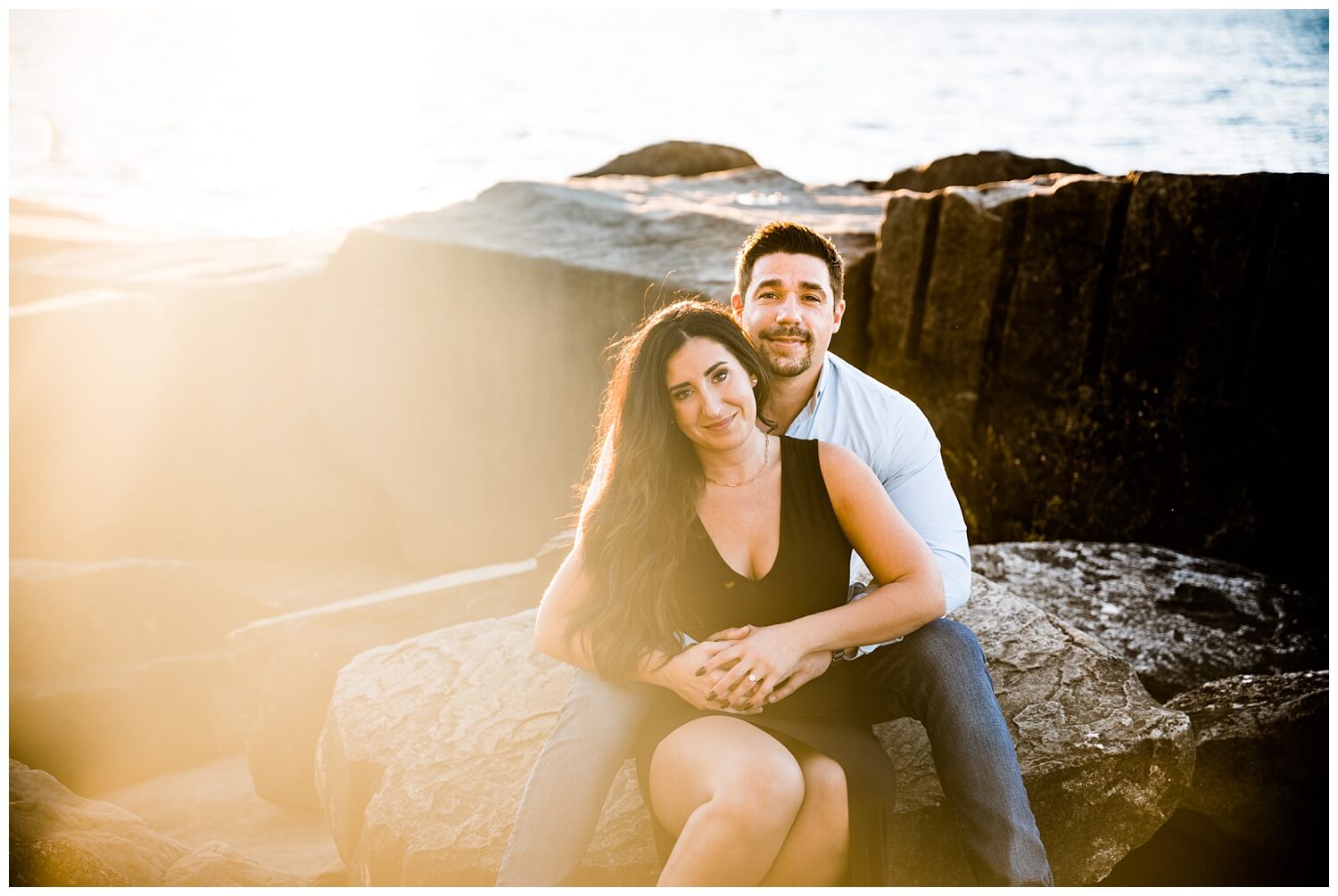couple on rocks during edgewater beach ohio engagement photos