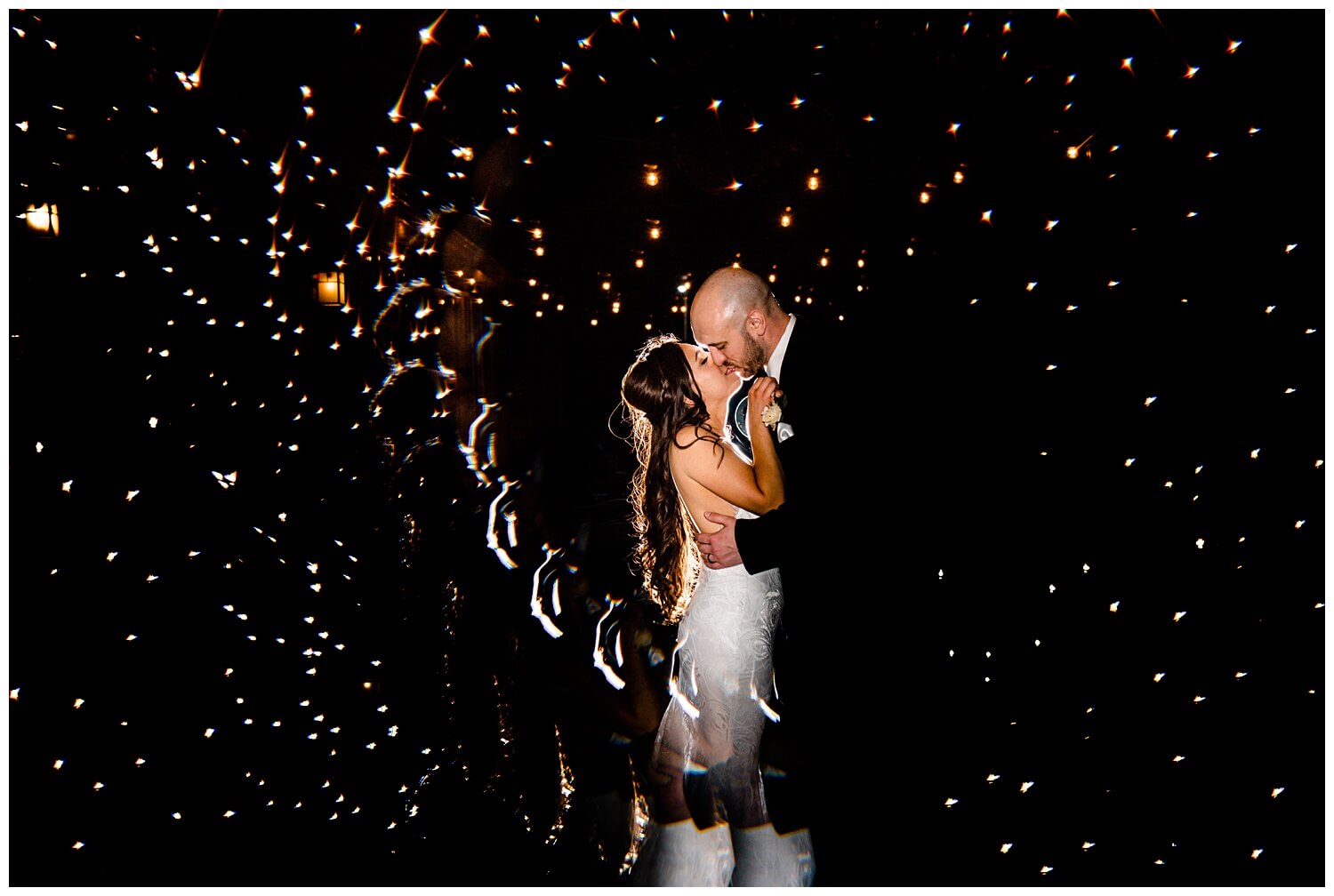 bride and groom kissing at night at tanglewood club wedding