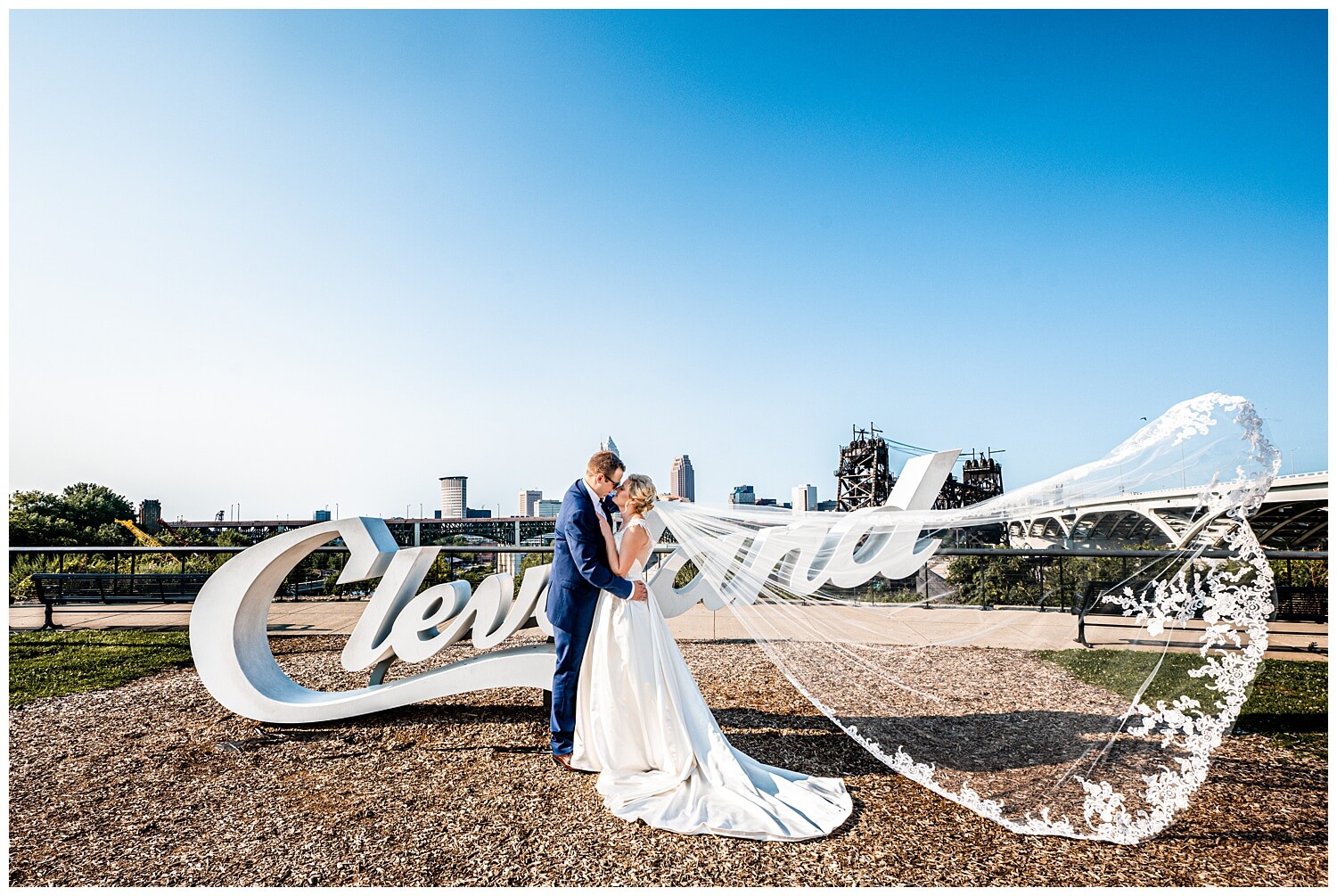bride and groom in front of cleveland sign at Ariel Pearl Center Wedding