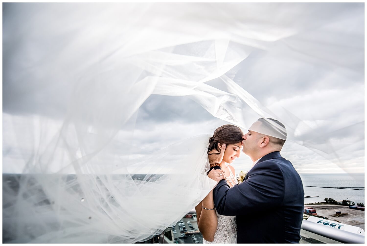 bride and groom on rooftop at lago custom events wedding captured by three and eight photography in cleveland
