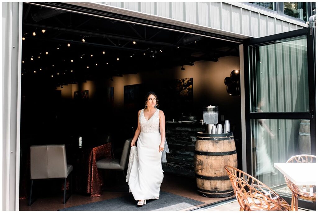 bride walking out of sapphire creek winery on wedding day to find her groom