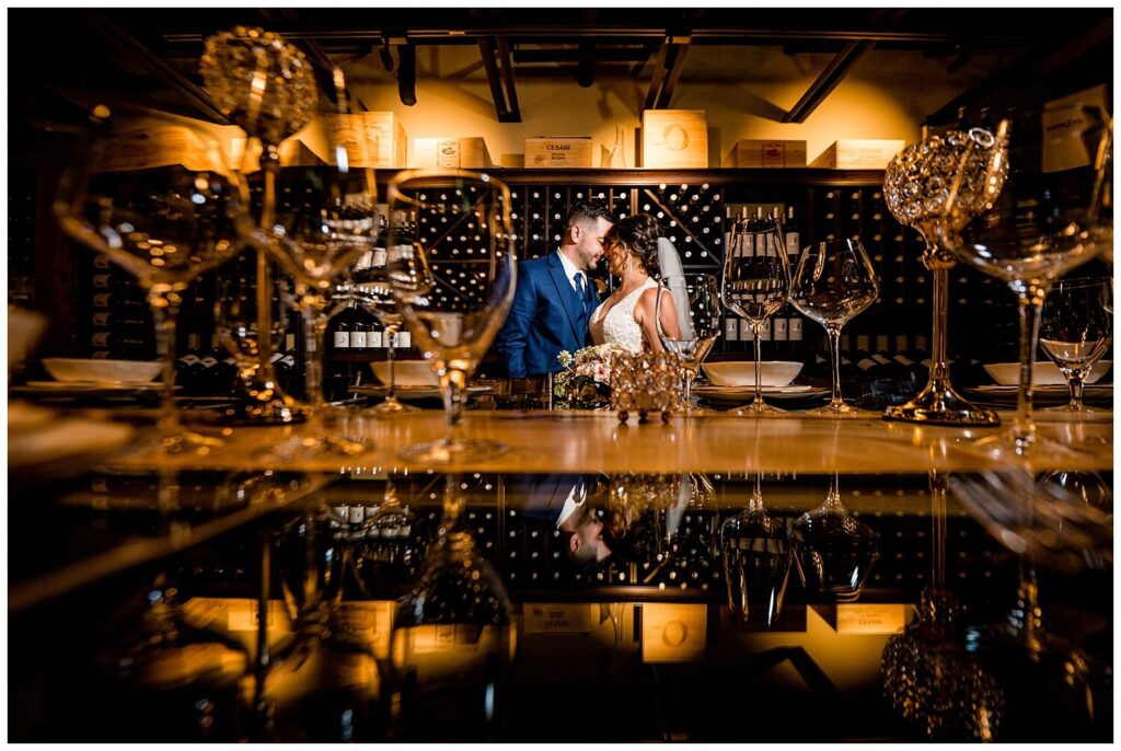 bride and groom in wine room at sapphire creek winery wedding captured by three and eight photography
