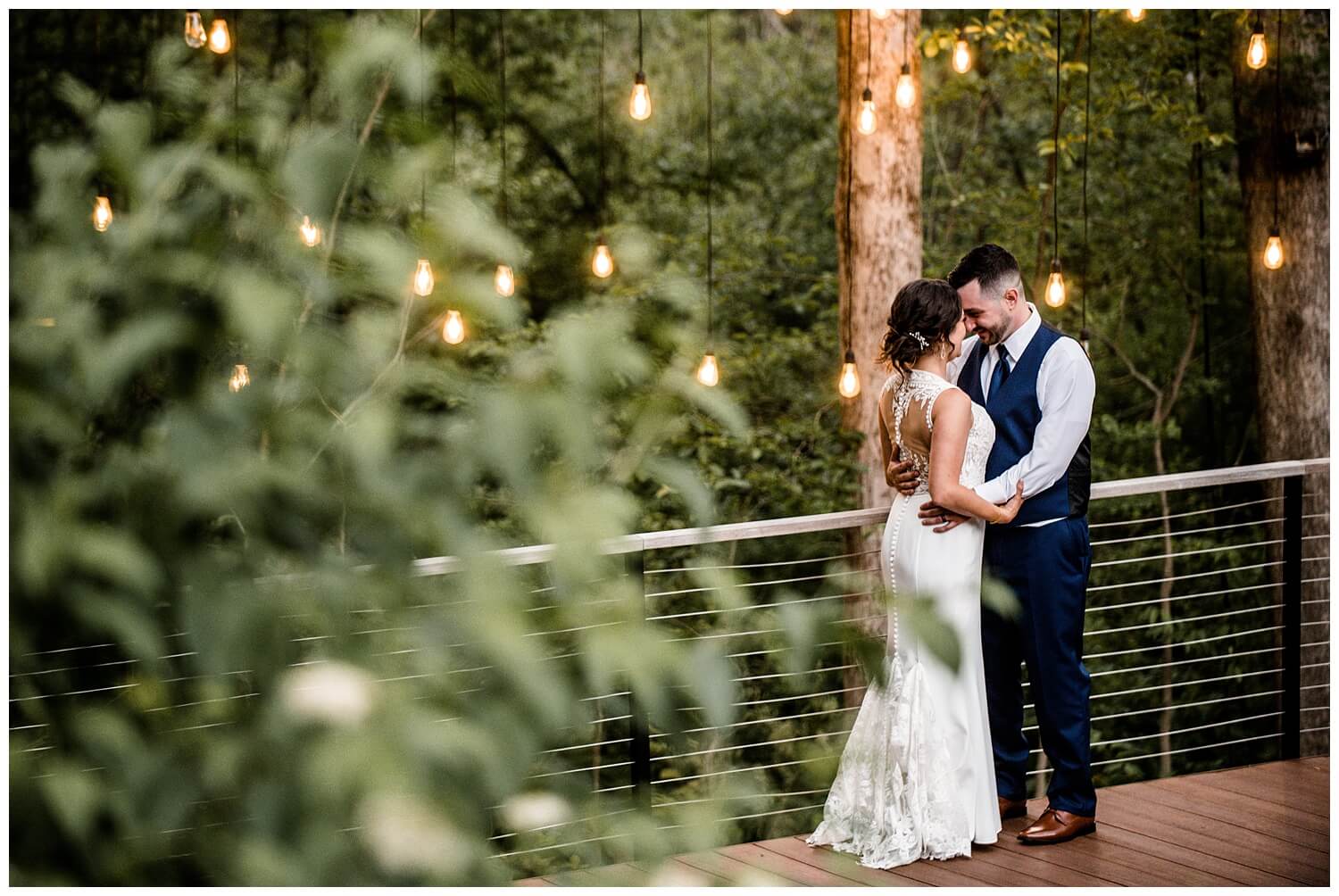 bride and groom holding each other at Sapphire Creek Winery Wedding captured by three and eight photography