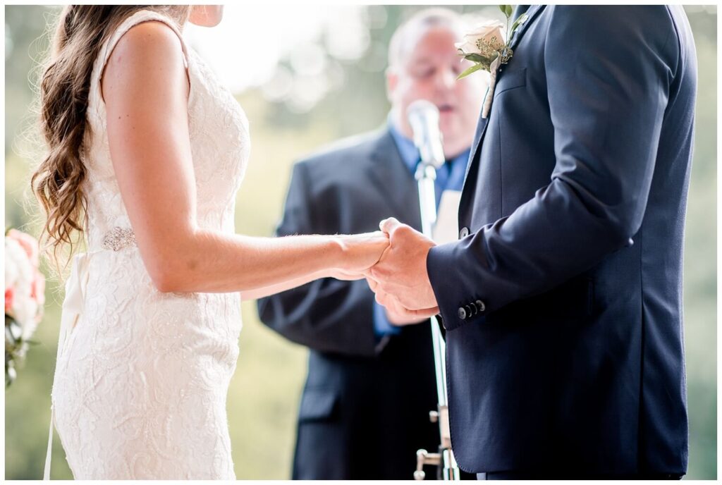 bride and groom holding hands during ceremony at cleveland zoo wedding