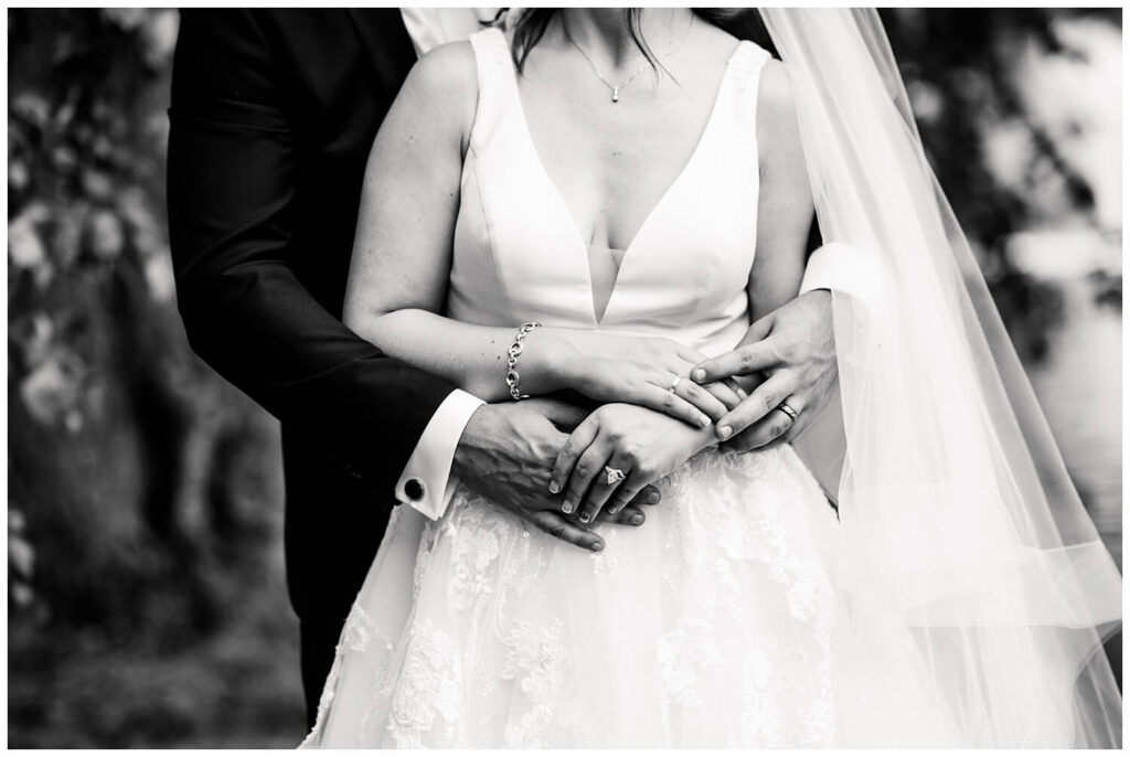 black and white photograph of bride and groom holding hands at glenmoor country club wedding in canton ohio