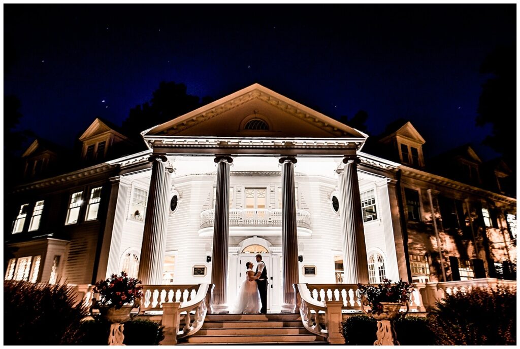 bride and groom at night in front of mooreland mansion on wedding night