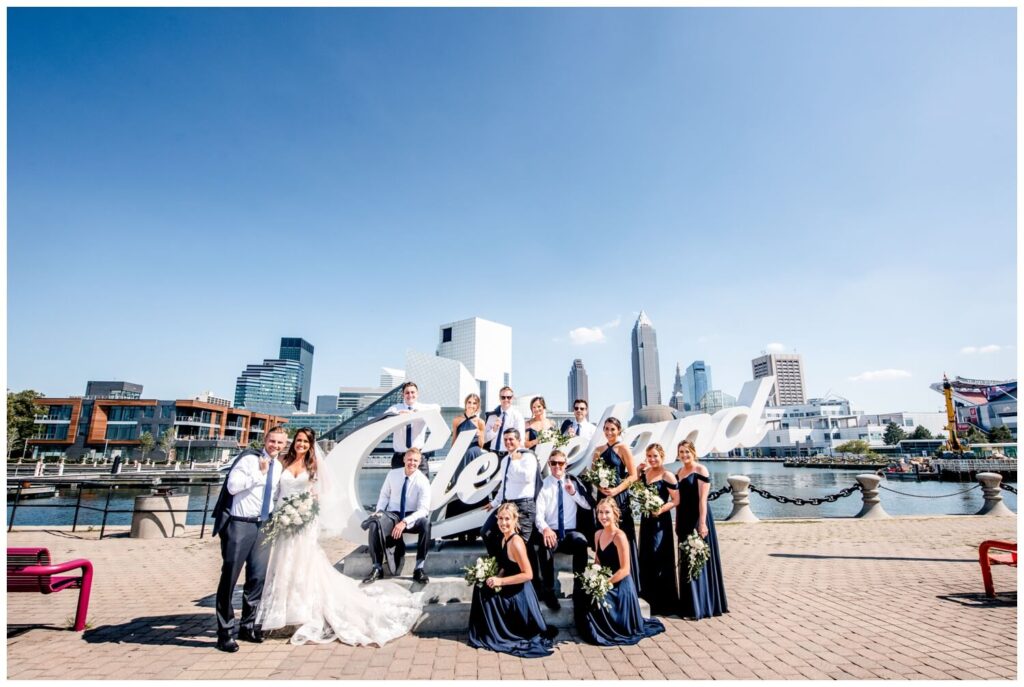 bridal party in front of cleveland script sign in northeast ohio