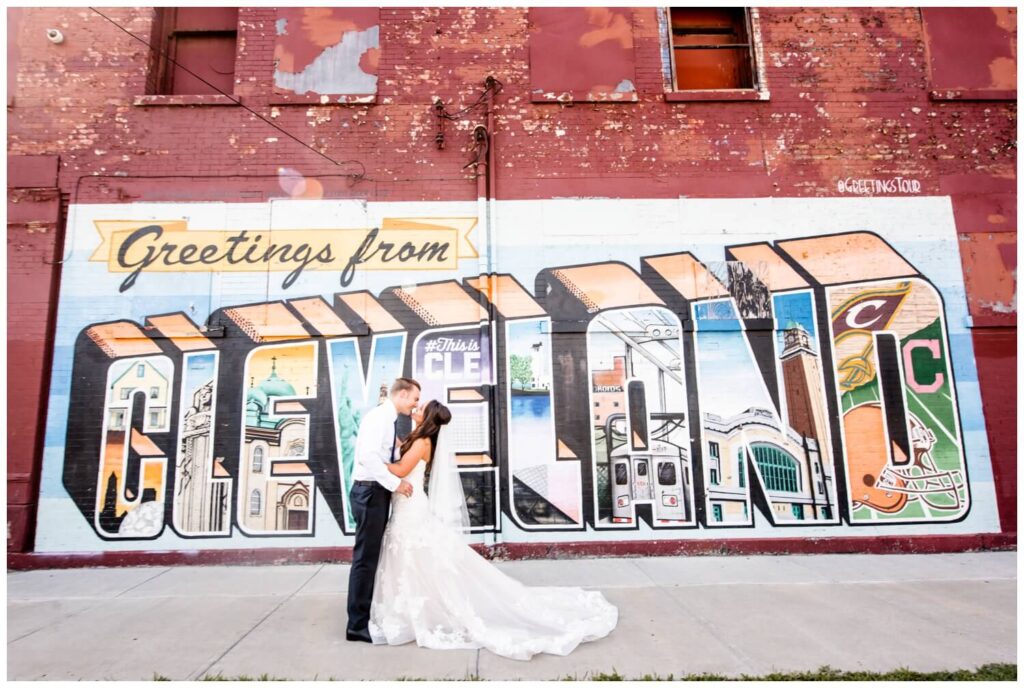 bride and groom in front of cleveland mural on northeast ohio wedding day