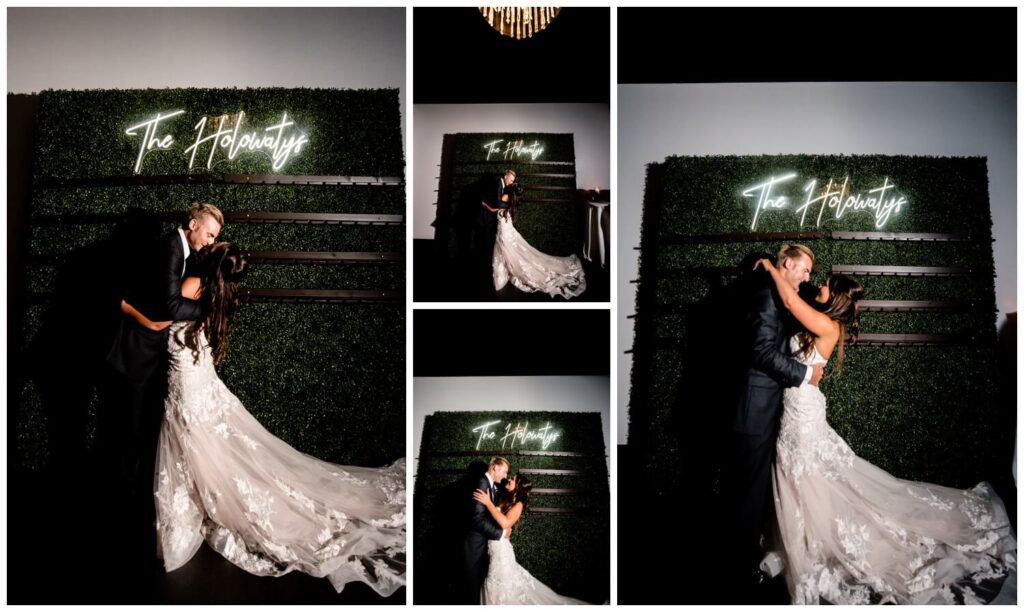 bride and groom kissing in front of champagne wall at windows on the river wedding reception
