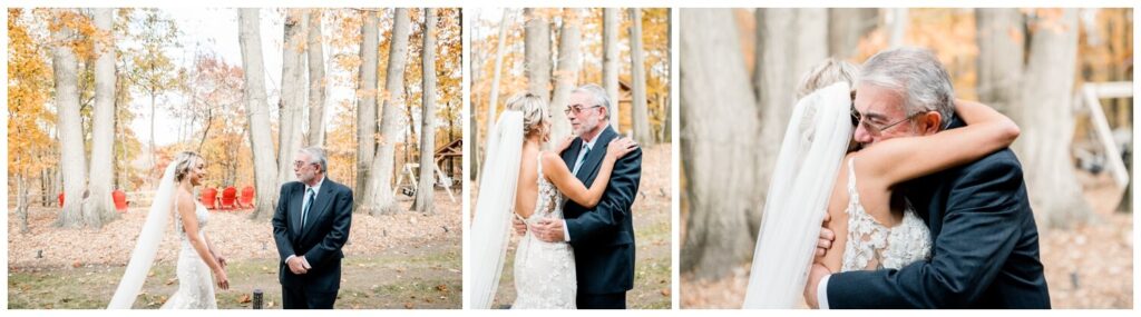bride and father hugging outside of tall oaks barn on fall wedding day