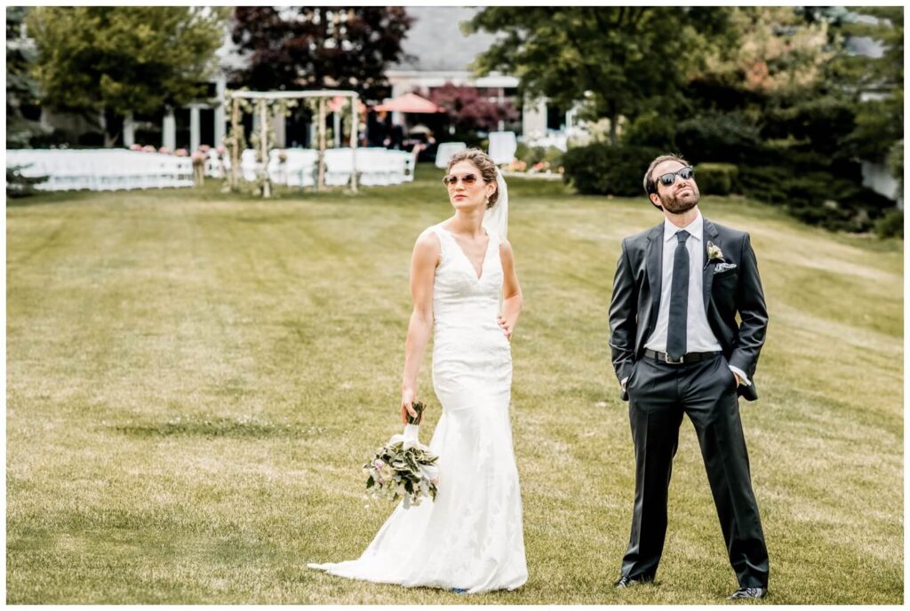 bride and groom wearing sunglasses outside at walden inn on wedding day