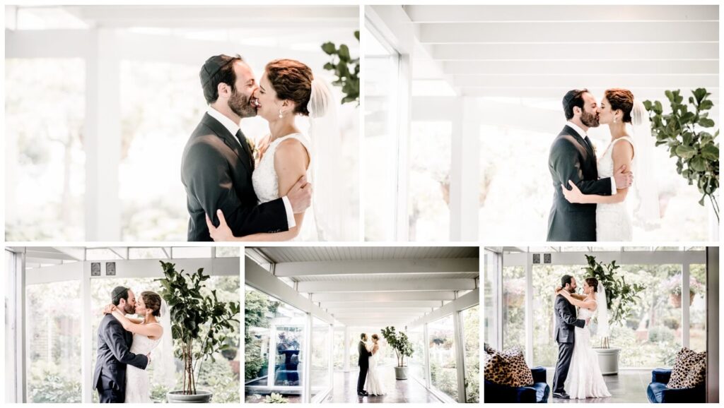 bride and groom kissing in hallway at walden inn wedding
