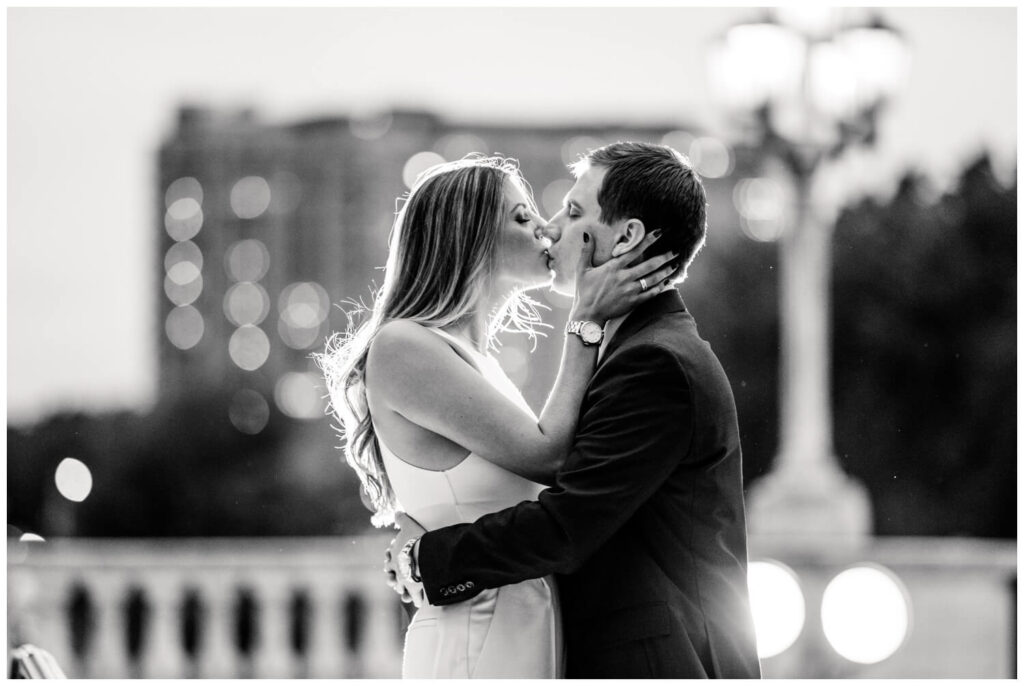 black and white engagement photo of bride and groom kissing at the cleveland art museum