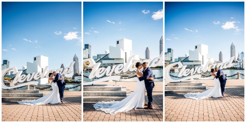 bride and groom standing in front of Cleveland sign on wedding day