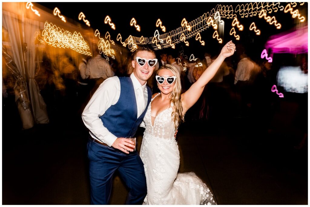 bride and groom posing in sunglasses at aloft downtown cleveland wedding reception