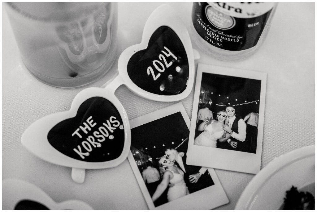 black and white photo of sunglasses and polaroid photos of bride and groom