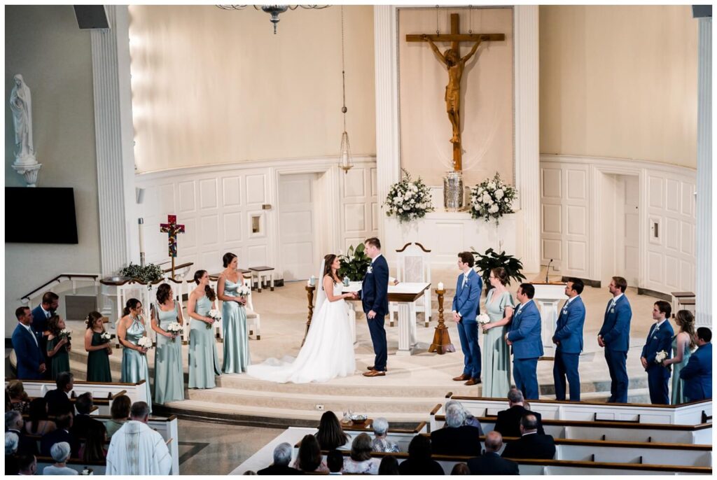 bride and groom holding hands on the alter at cleveland wedding ceremony