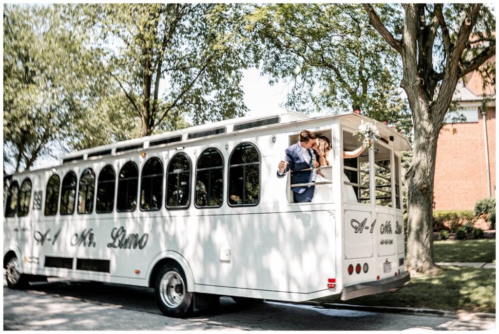 bride and groom kissing on trolley at glidden house wedding in cleveland ohio