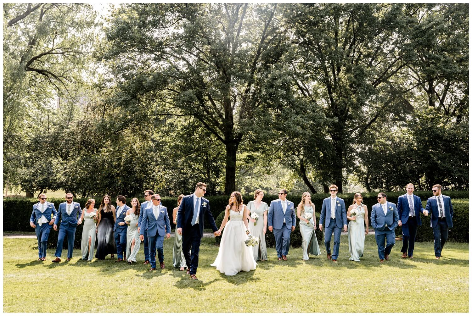 bride and groom walking with bridal party at Glidden House wedding in cleveland ohio