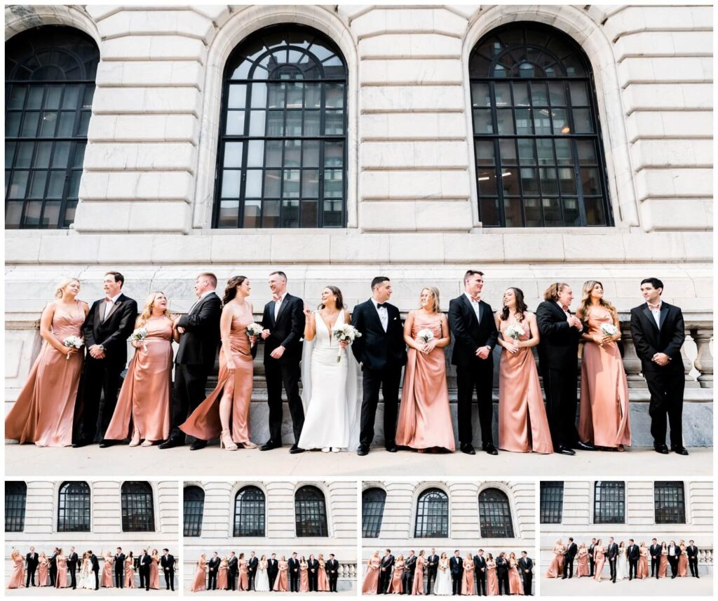 bride and groom posing with bridal party at the cleveland public library on wedding day