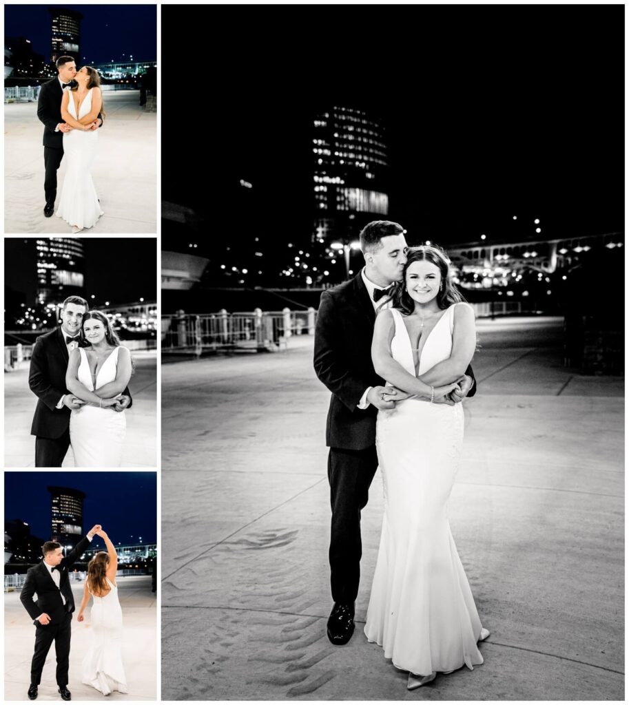 bride and groom posing outside at night at windows on the river in cleveland ohio